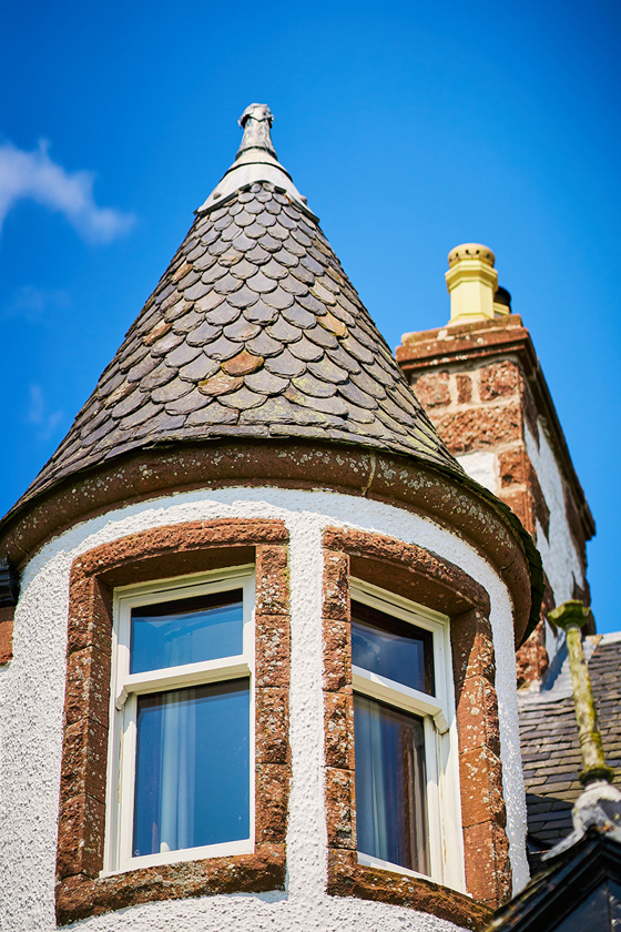 Blue skies with turret at Kinclune House in foreground